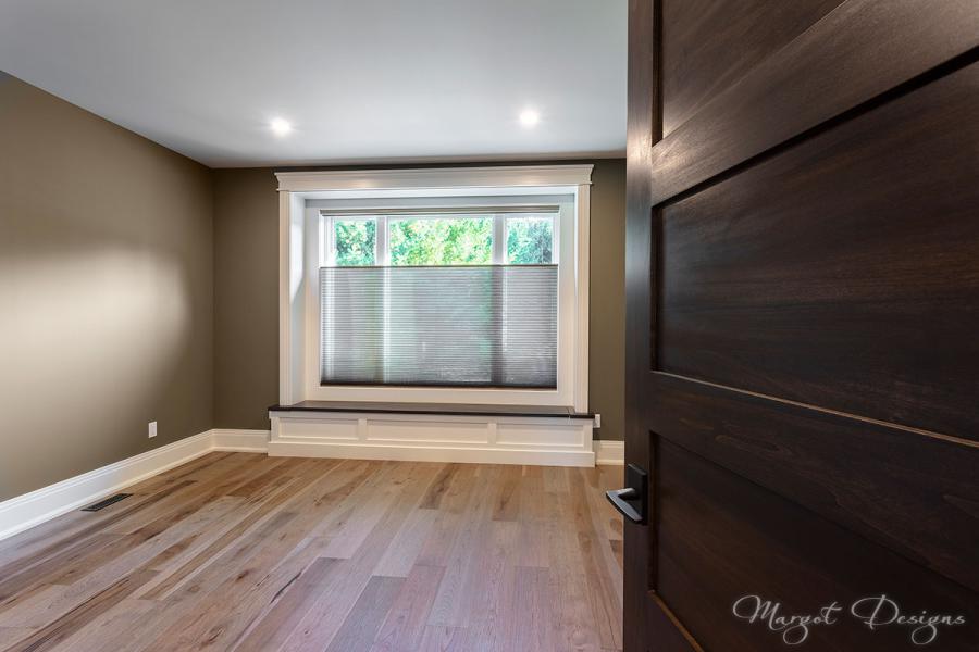 Bedroom with window seat and custom trim